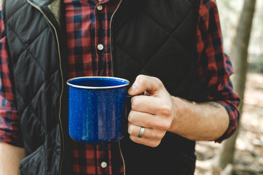 Man holding metal mug